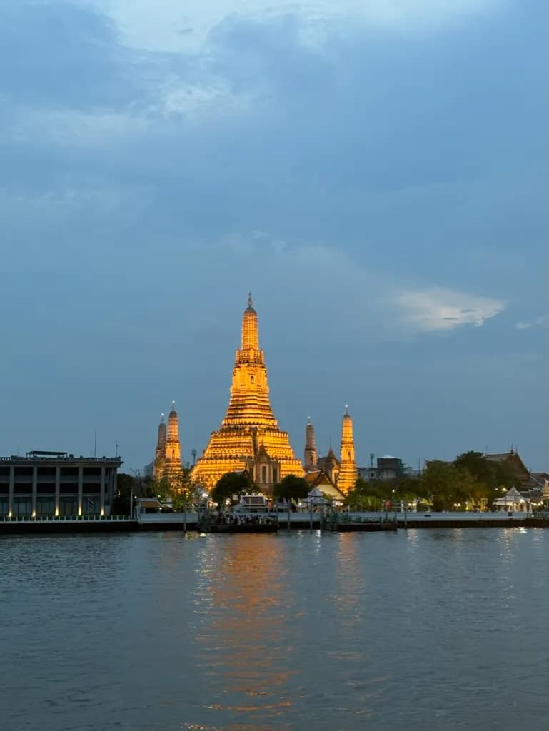 Wat Arun temple illuminated at night in Bangkok