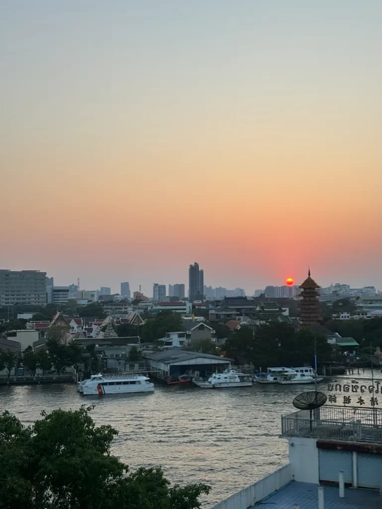 Bangkok skyline viewed from a rooftop bar at sunset